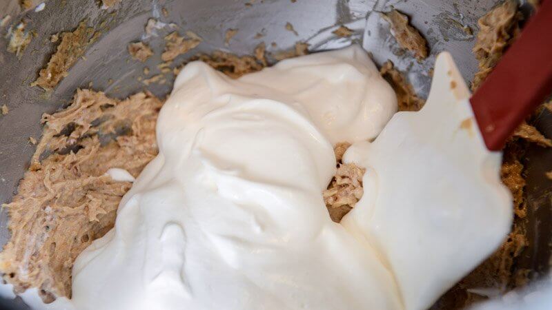 Folding the whipped cream into the praline filling