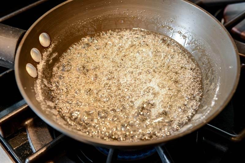 Cooking sugar for the caramelized hazelnuts.