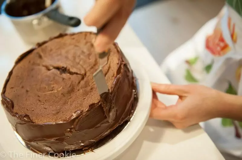 Smooth the ganache on the sides first.