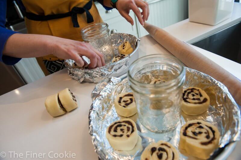 Filling the pan with sticky buns.