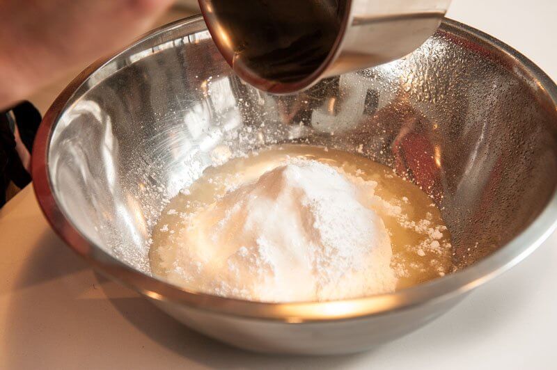 Liquid ingredients added to the powdered sugar (sans water).