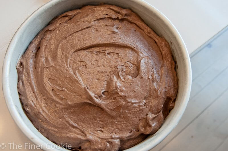 Mixing the very dark cocoa powder with hot water.