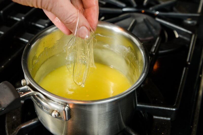 Drop softened sheet gelatin directly into Lemon Custard, used in many Finer Cookie recipes.