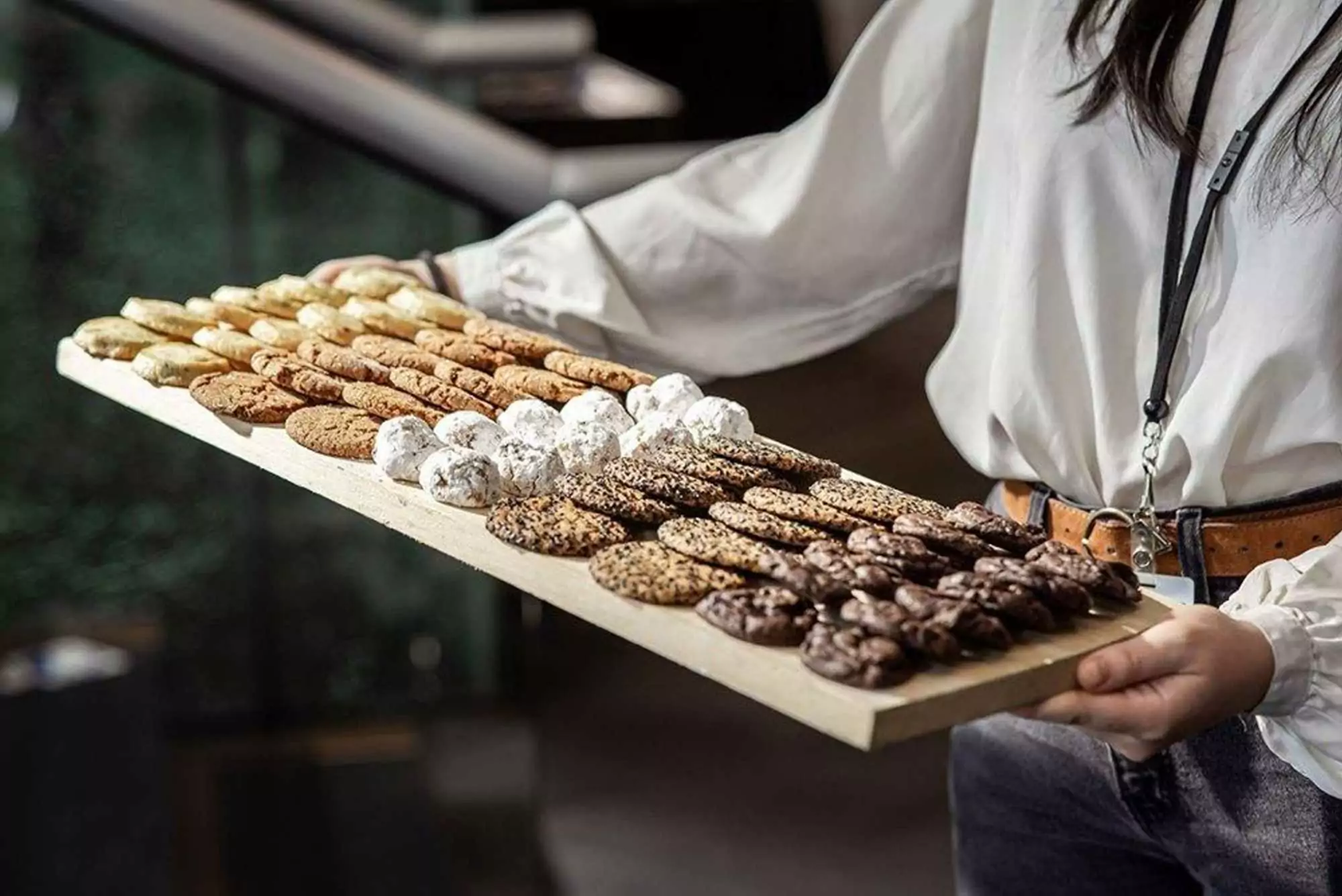 Variety of gourmet cookies being carried to a table