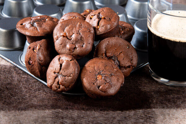 Chocolate Cookies with Irish Stout and Crunchy Pecans stacked on baking tin