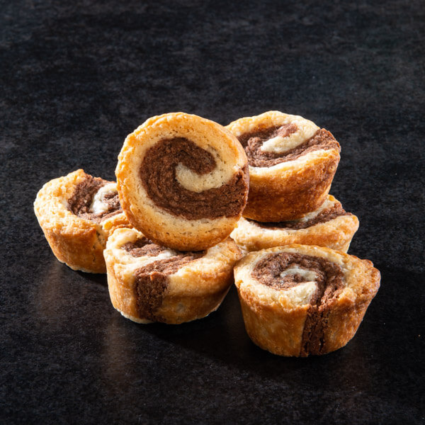 Cinnamon Roll Cookies placed on table with cinnamon sticks